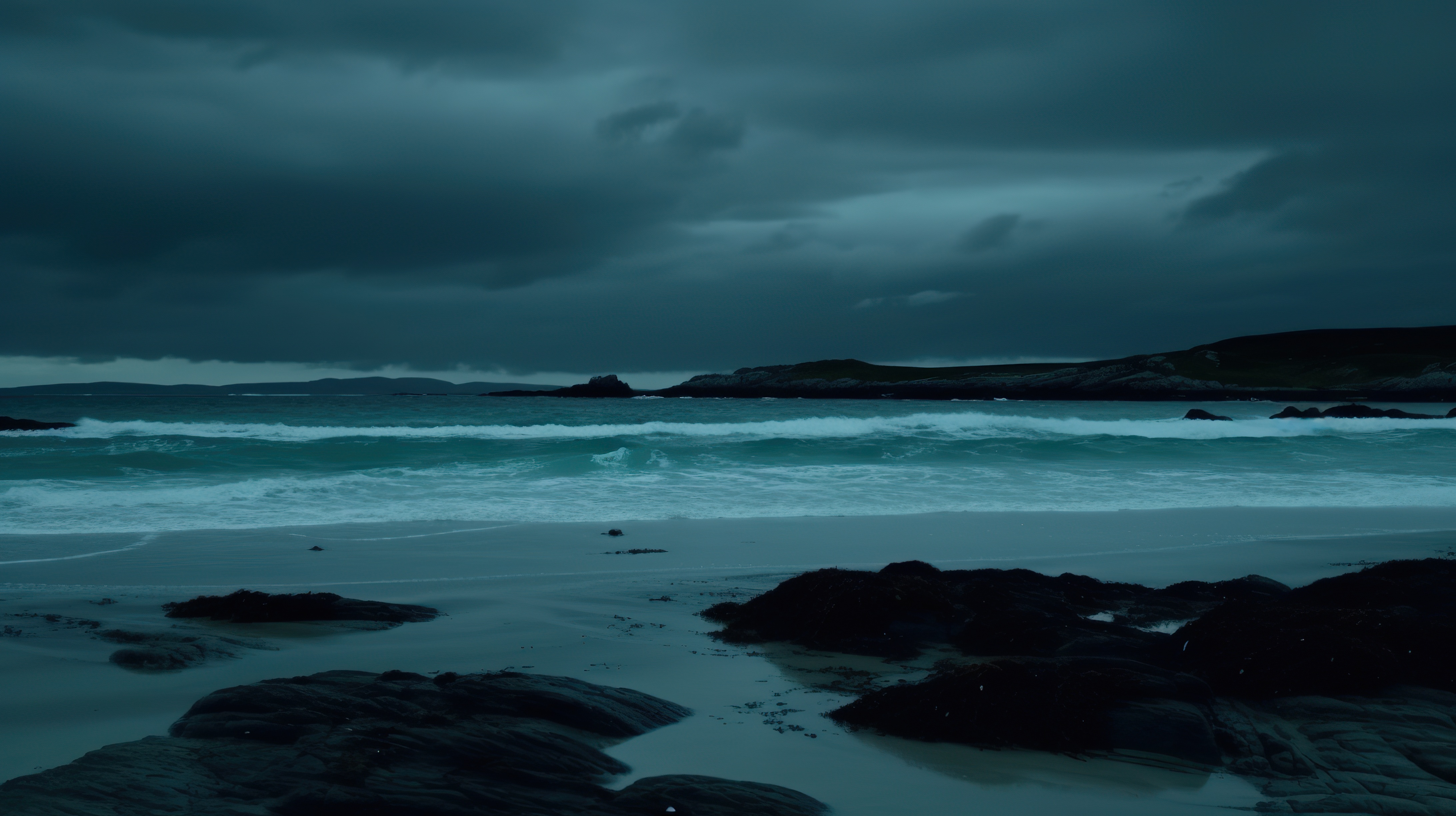 Sky with dark clouds and a beach with calm water and rocks on the shore