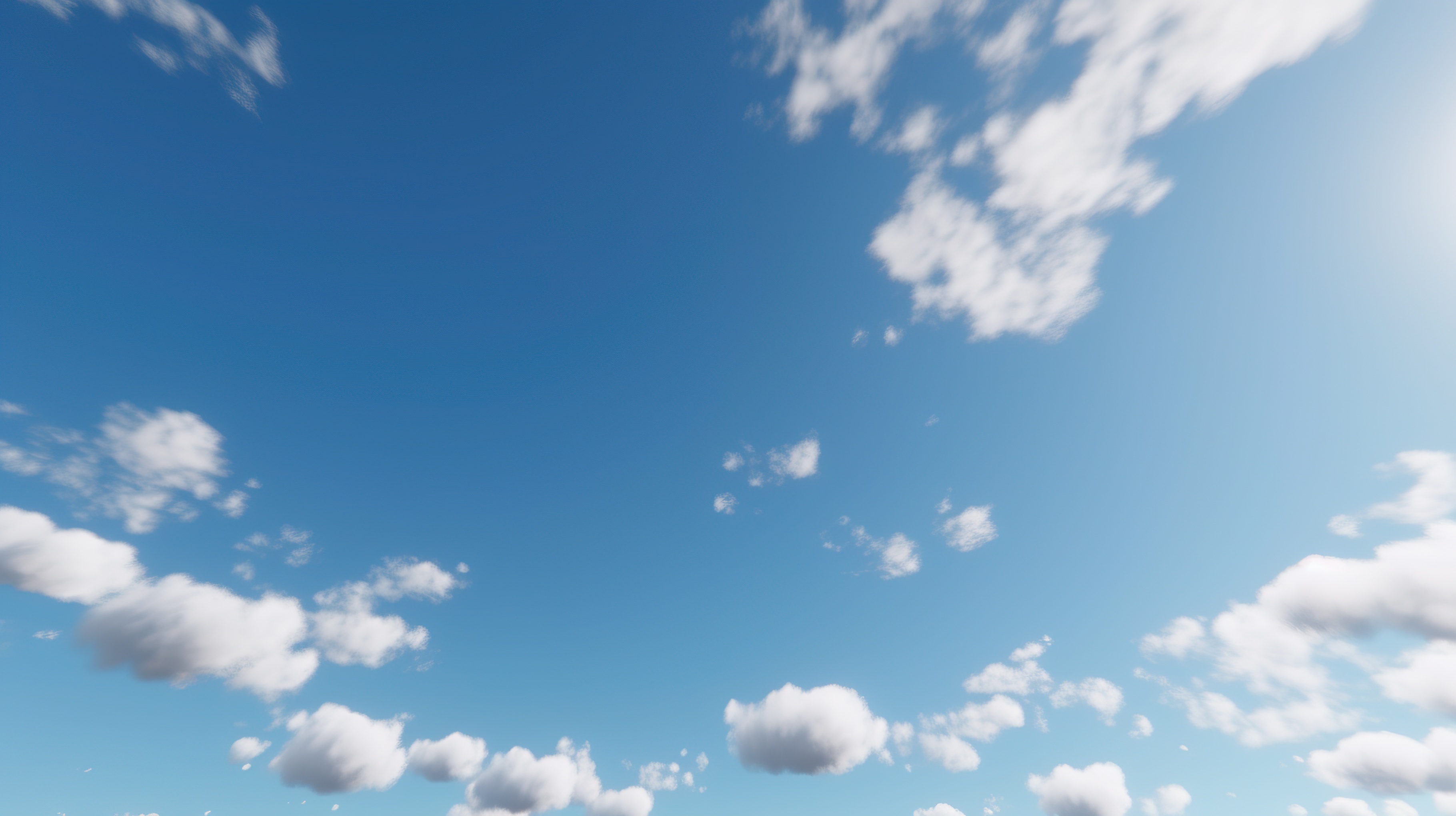 A clear blue sky with fluffy white clouds scattered throughout