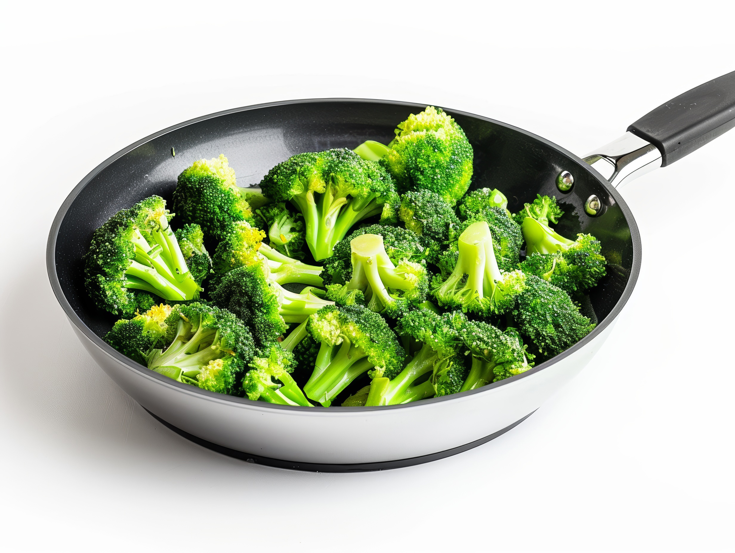 Broccoli florets in a frying pan close up isolated on white background