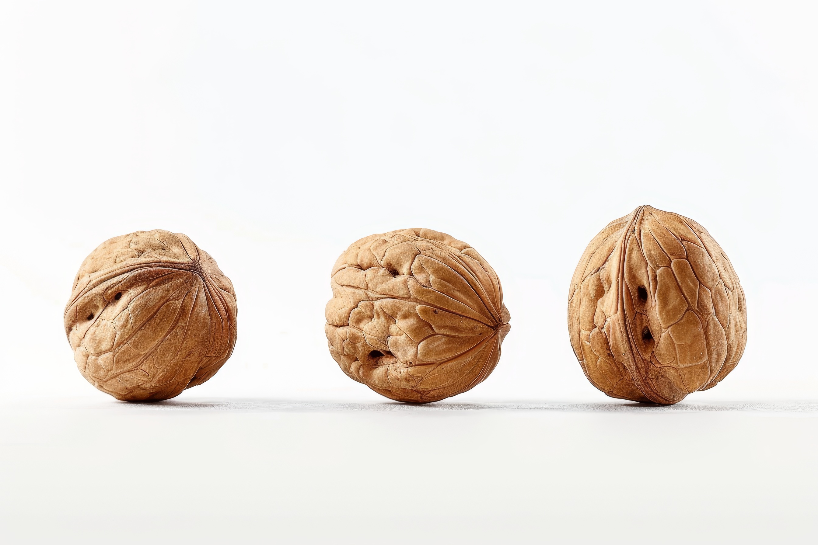 Three walnuts isolated on white background